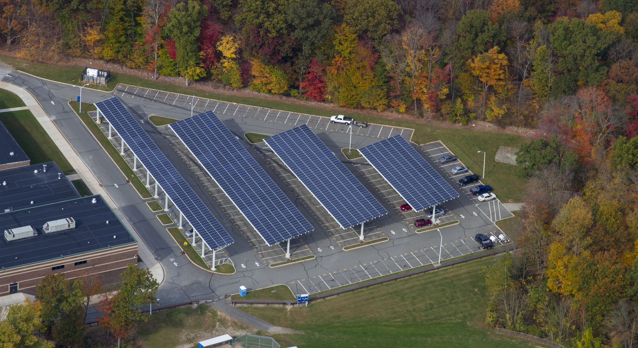 Aerial view of solar carport canopies at Kittatinny High School in autumn